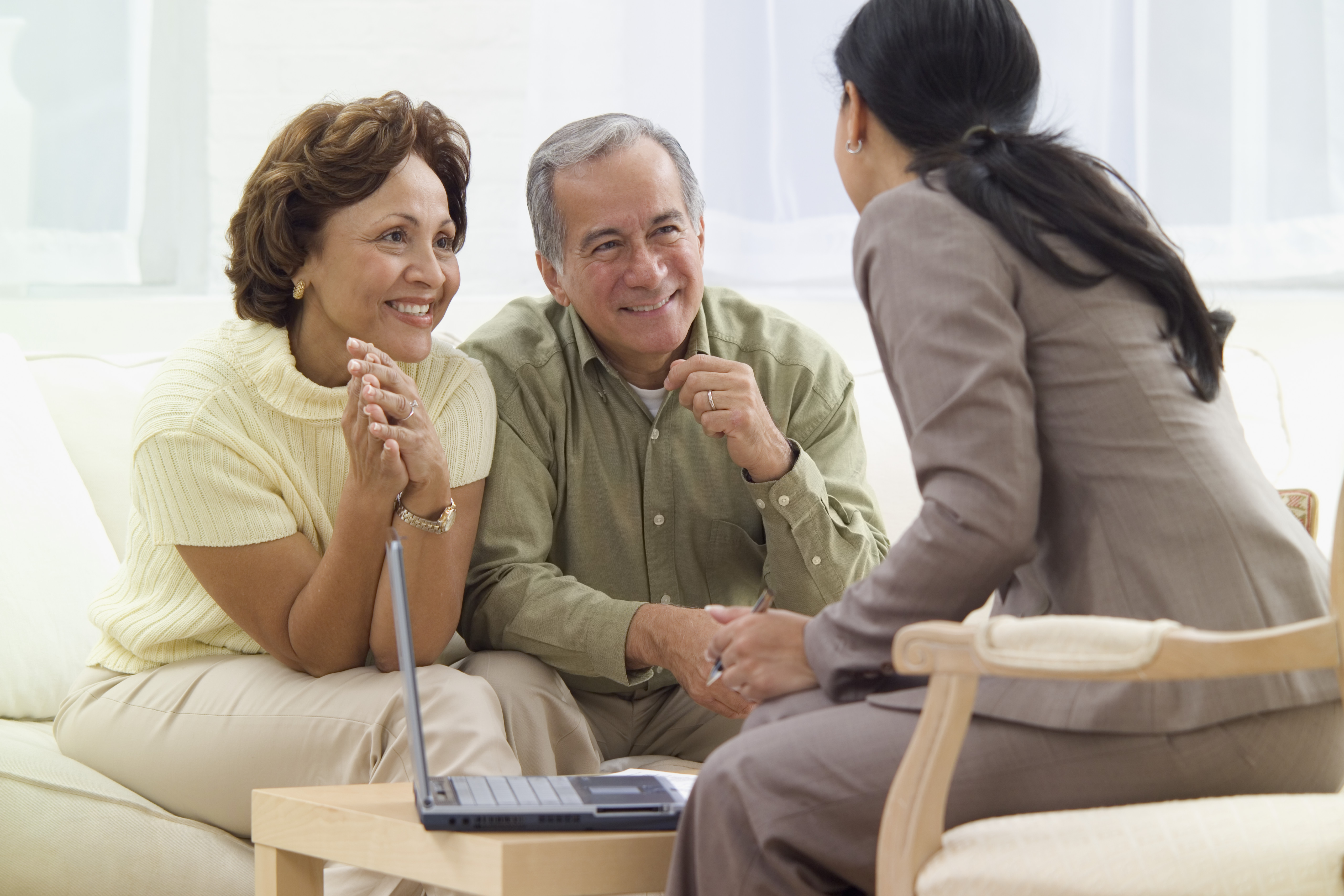 Elderly couple talking to loan officer